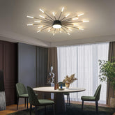 Modern dining room with a stylish ceiling light fixture, round table, and green chairs.